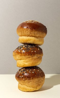 Renkli bir arka planda tohum ve yüksek kontrastlı ışıkla çeşitli ev yapımı çörekler.