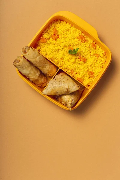 Ev yapımı kuskus, sebzeli ve tipik Arap yemeklerinden oluşan bir beslenme çantasında. Götürün. İş konseptinde yiyecek