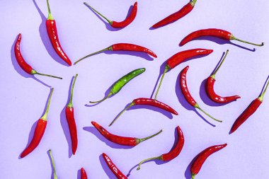 Background hot chili peppers on colorful backgrounds from above with sunlight. Flat lay. top view
