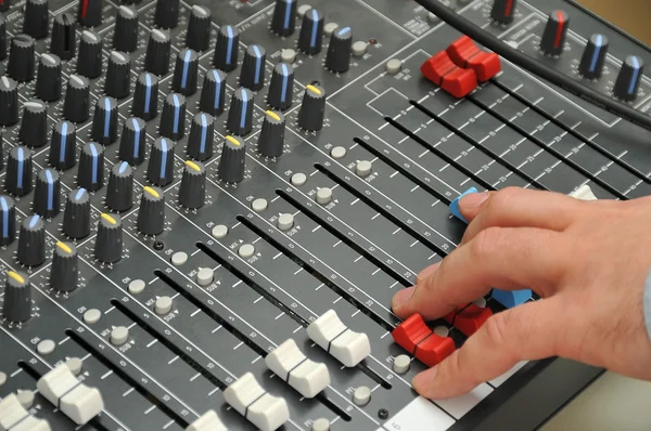 Hand of the sound producer and mixer console — Stock Photo, Image