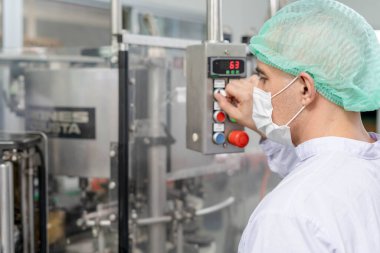 Mühendisler gıda üretimindeki kirliliği azaltmak için maske, şapka ve cübbe giyerler. Müfettişler, standartları karşılamak için sistemi test etmek amacıyla fabrikada makineler ve sterilizatörler açıyor. makine bakımı