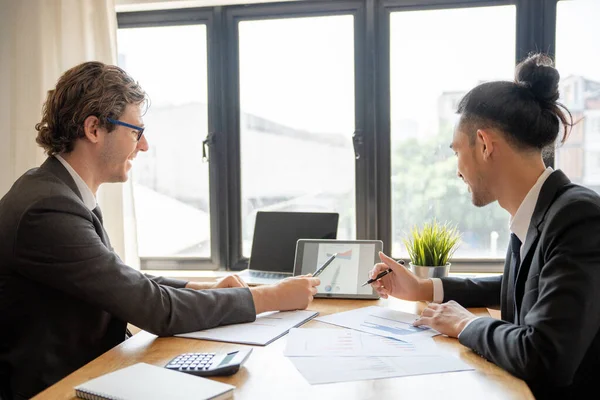 Analysts or financial advisors provide advice on securities analysis and bank treasury. A businessman presents a documented investment plan through graphs and charts. Brainstorm and work together