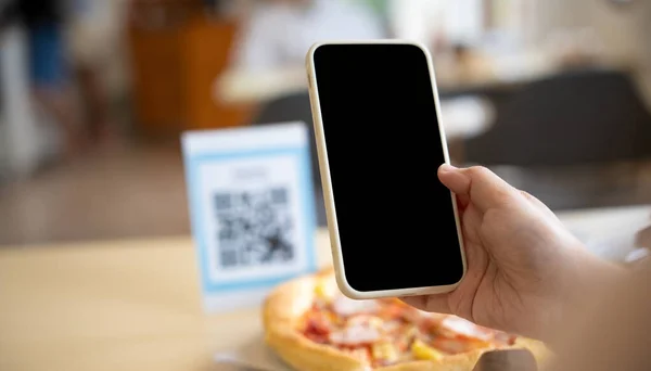 people use smartphone to scan QR code in cafe. The restaurant built a digital payment system without cash. Qr code pay, E wallet, cash technology, pay online