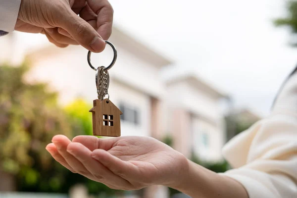 Home buyers are taking home keys from sellers. Deal contract complete. Sell your house, rent house and buy ideas.