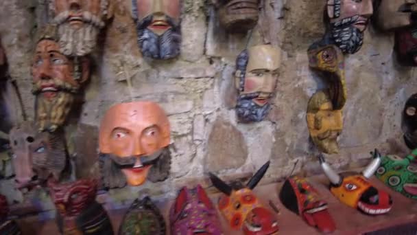 Sold Souvenirs Weird Traditional Latin American Masks Grouped Cave Rock — стоковое видео