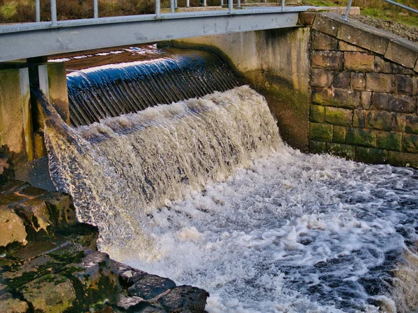 イングランド北部ランカシャー州のホワイトデール川の水管理堰の上に水が流れ込む 堰のデザインは マスやサケの上流への移行に役立ちます — ストック写真