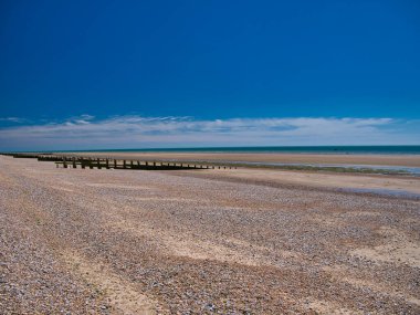 Dungeness, Kent, İngiltere 'de terk edilmiş bir sahil. Yazın güneşli bir günde çekilmiş..