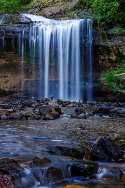 Wilke Glen and Cascade Falls in Osceola, Wisconsin during summer. Selective focus, background blur and foreground blur.