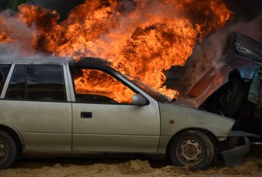 Old car on fire after a traffic accident
