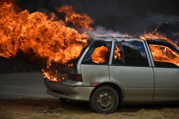 Old car on fire after a traffic accident