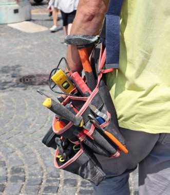 Worker walks on the street with tools