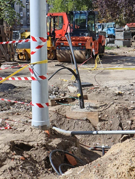 Electricity pole under construction on the street