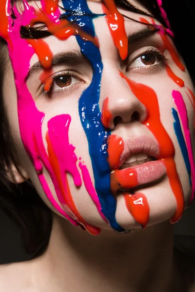 Girl with paint on her face — Stock Photo, Image