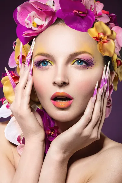 Mulher bonita com cabelo feito de flores e unhas compridas — Fotografia de Stock