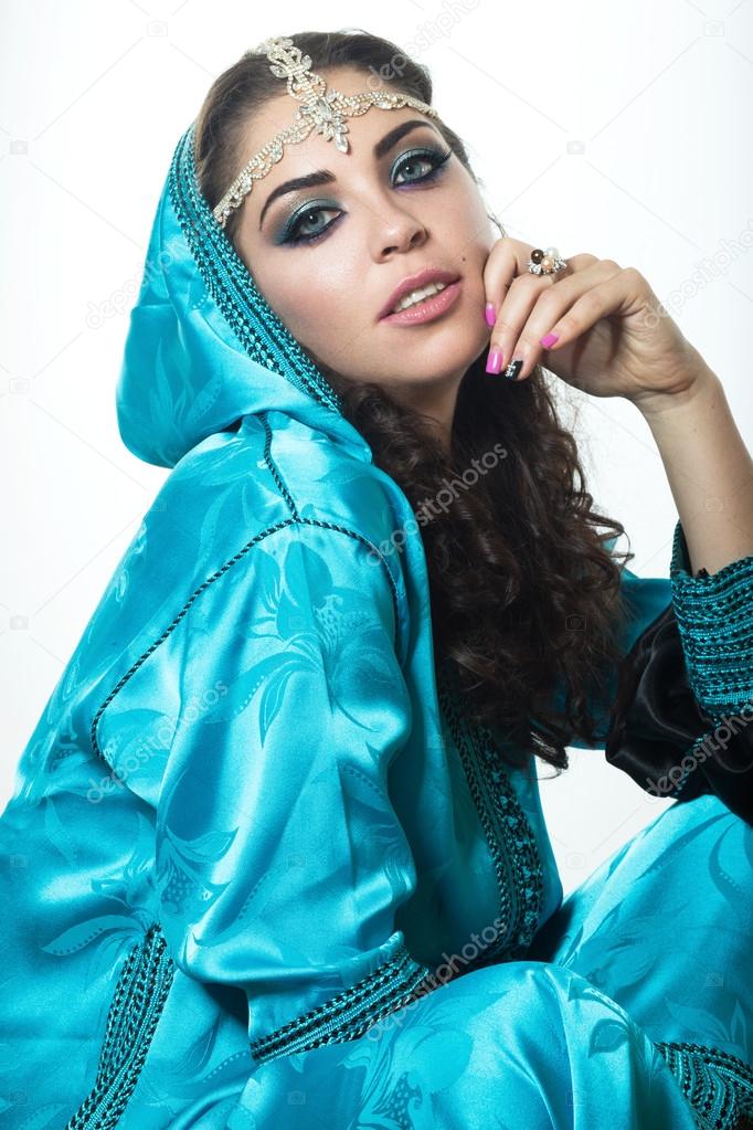 Beautiful girl in the Arab image with bright oriental make-up.