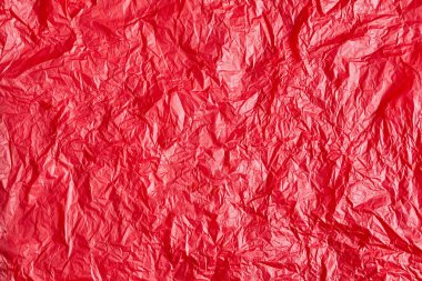 Tasarım için kırmızı buruşmuş kağıt veya yaprak dokusu arka planı. Metin için duvar kağıdı.