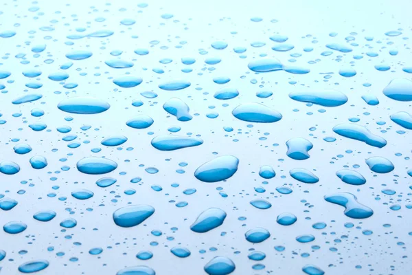 Waterdruppels Blauwe Achtergrond Druppels Water Het Oppervlak Macro Foto Splash — Stockfoto