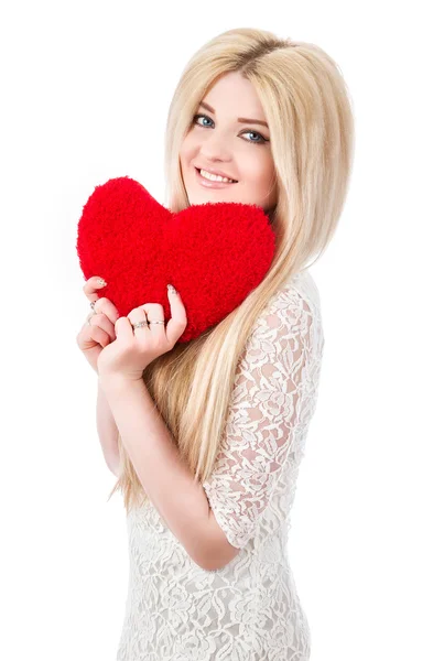 Beautiful smiling blonde girl with heart in hands — Stock Photo, Image