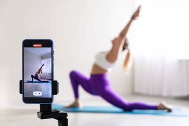 Yoga yapan kadın, telefon kamerasının önünde poz veriyor spor blogcusu öğretmen yoga online sınıf sağlık koçu