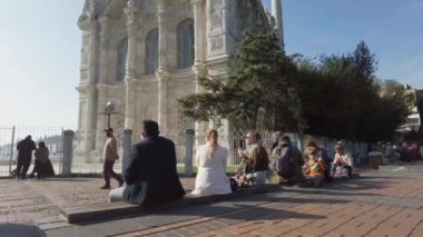 Ortakoy Camii 'nde insanlar yürüyor, meydanda oturuyor. Türkiye İstanbul Eylül 2021