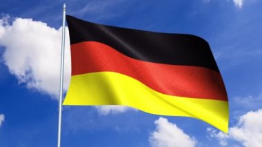 Alman bayrağı mavi gökyüzü karşı rüzgarda sallayarak