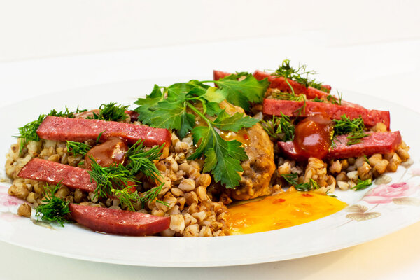 Buckwheat cereal with sausage, greens and cutlet