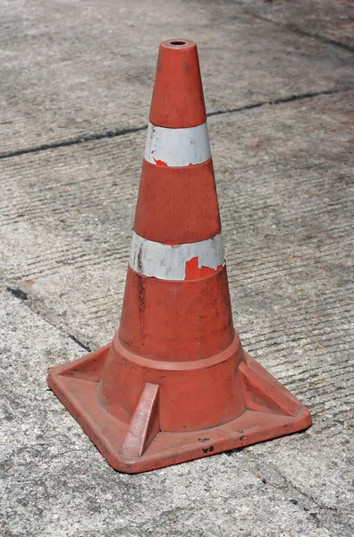 Old traffic cone on bitumen pavement — Stock Photo, Image
