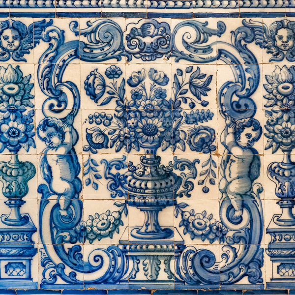 Traditional Portuguese, glazed ceramic tiles. Azulejos white, blue ornate pattern, for design, backdrop. Abstract background from old decorative painted tiles, religious theme with angels and flowers.
