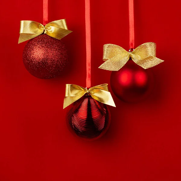 奢华时尚的圣诞舞会 金色的蝴蝶结挂在缎带上 背景深红色 正方形 小册子设计的圣诞背景 — 图库照片