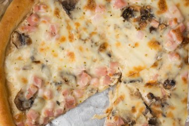 Karton bir kutuda ve folyoda taze pişmiş pizza.