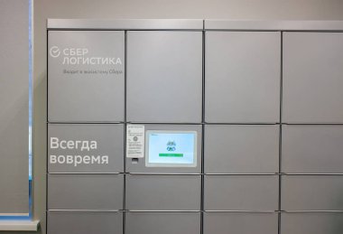 Arkhangelsk Rusya 12-28-2021: Sberbank şubesindeki Sber lojistik çevrimiçi mağazalarından mal ve mal alımı için modern gri paket terminali