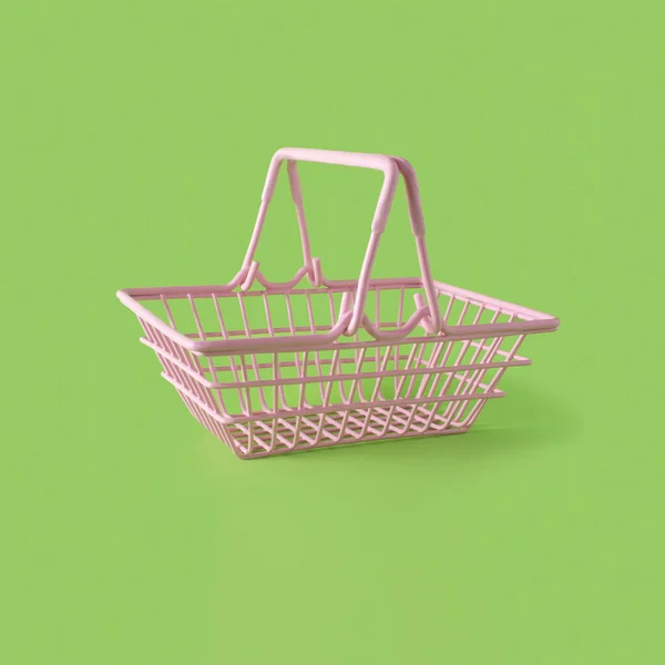 Pink Metal Shopping Basket Green Background Copy Space Horizontal Composition — Zdjęcie stockowe