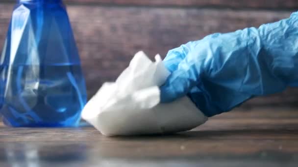 Hand in blue rubber gloves cleaning table with cloth — Stock Video