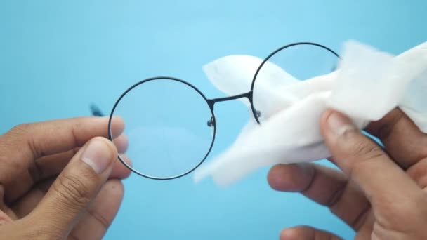 Närbild av man hand rengöring glasögon med vävnad — Stockvideo