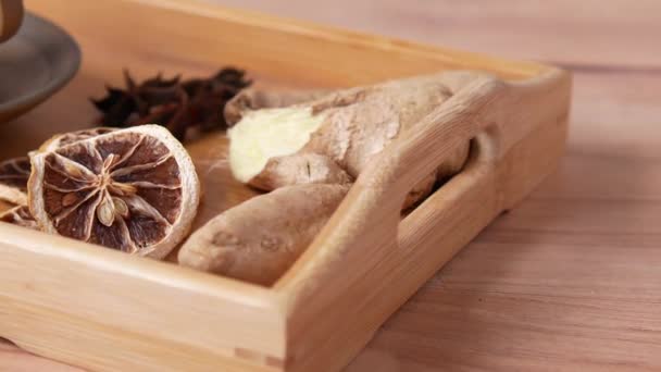 Close up of dry lemon, ginger and green tea on table — Stock Video