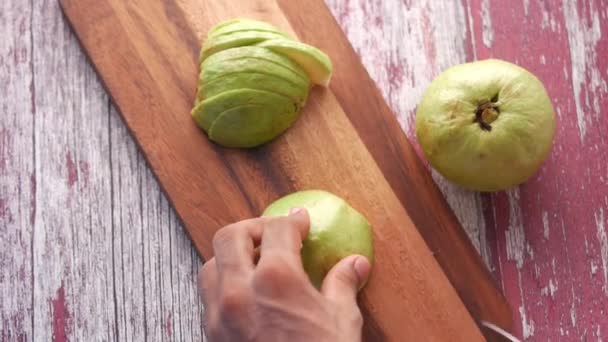 Close up of slice of guava on the drilling board , — стоковое видео