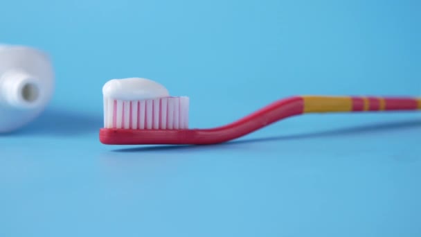 Tooth brush and paste on blue — Stock Video