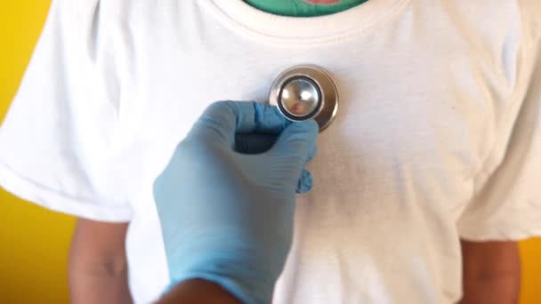 Doctor using a stethoscope checking body, close up — Stock Video
