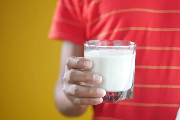 Child boy hand hold a glass of milk — Stock Photo, Image