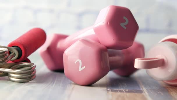 粉色哑铃，白色背景的运动垫和水瓶 — 图库视频影像