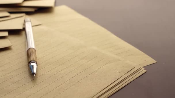 Enveloppe, leeg papier en vulpen op tafel — Stockvideo