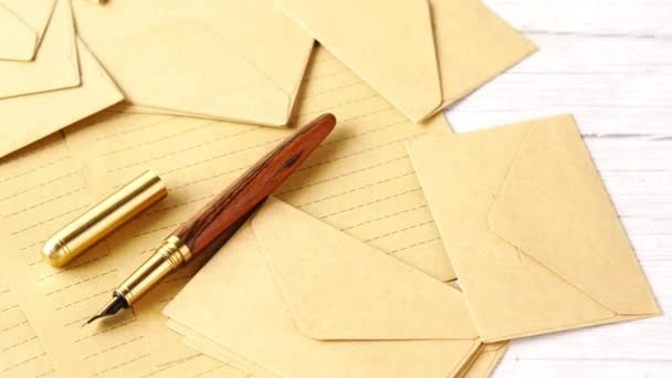 Envelope , empty paper and fountain pen on table — Stock Video