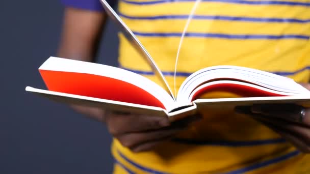 close up of young man hand reading a book 