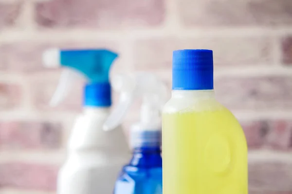 Floor cleaning disinfect bottle against brick wall — Stock Photo, Image