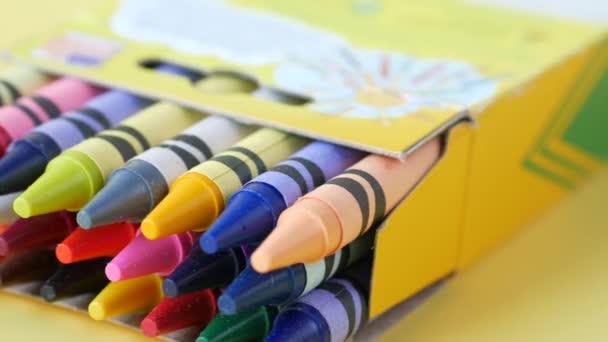 Color pencils on yellow papers on table — Stockvideo