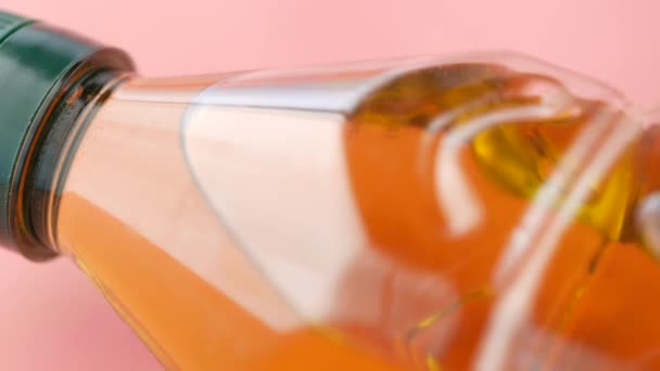 Detail shot of bottle of olive oil on pink background — 图库视频影像