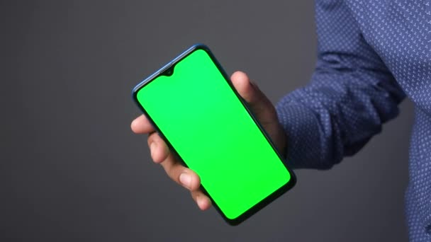 Close up of young man hand using smart phone with green screen — Stock video