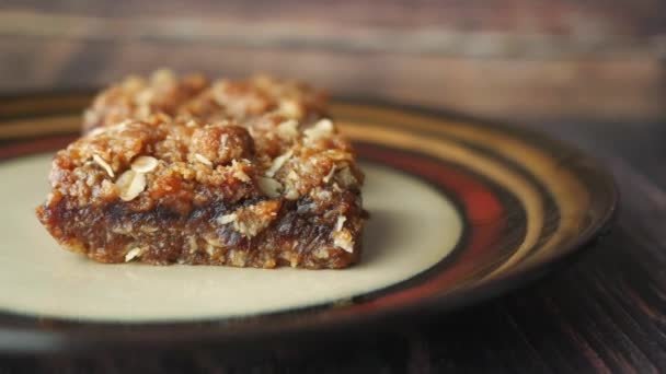 Fecha barra de chocolate de frutas en un plato en la mesa — Vídeos de Stock