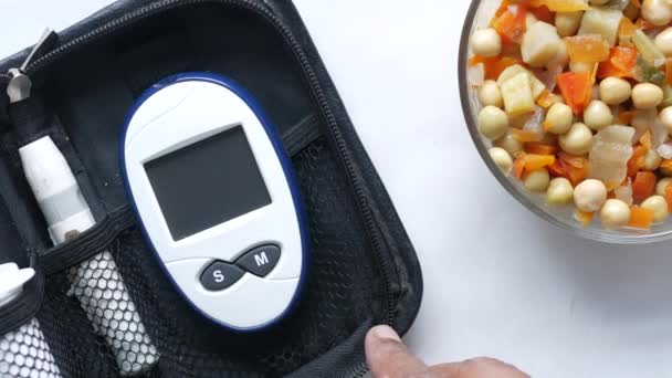 Mans mano mettendo misuratore di glucosio in un piccolo sacchetto — Video Stock