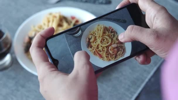 Young women taking photos of food with smart phone — Stockvideo